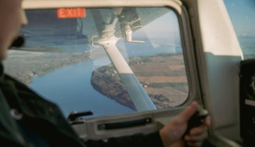 a-man-looking-out-the-window-of-an-airplane.jpg a man looking out the window of an airplane